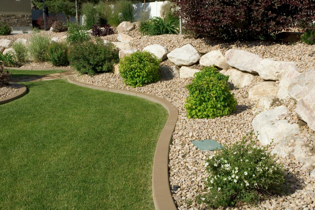 Neatly landscaped area with plants and decorative stones
