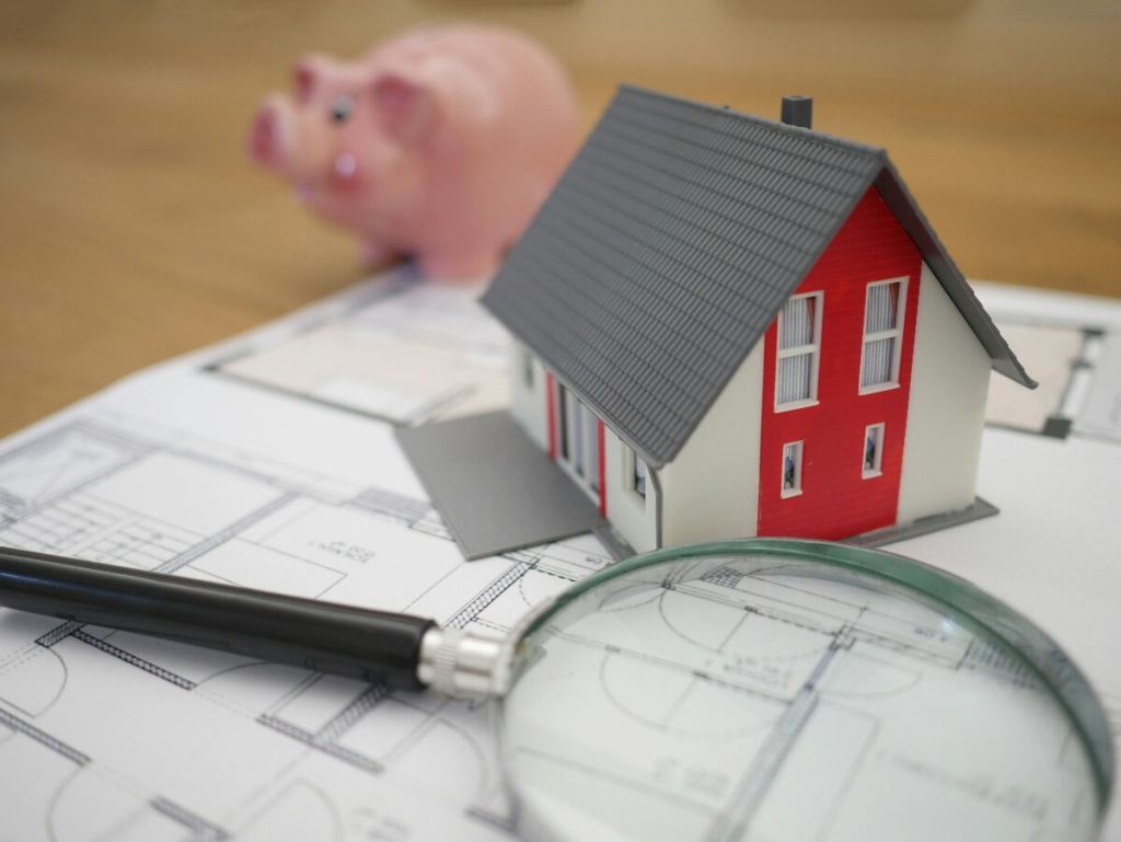 A miniature house with magnifying glass