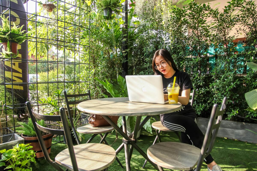 A woman using a laptop in a garden