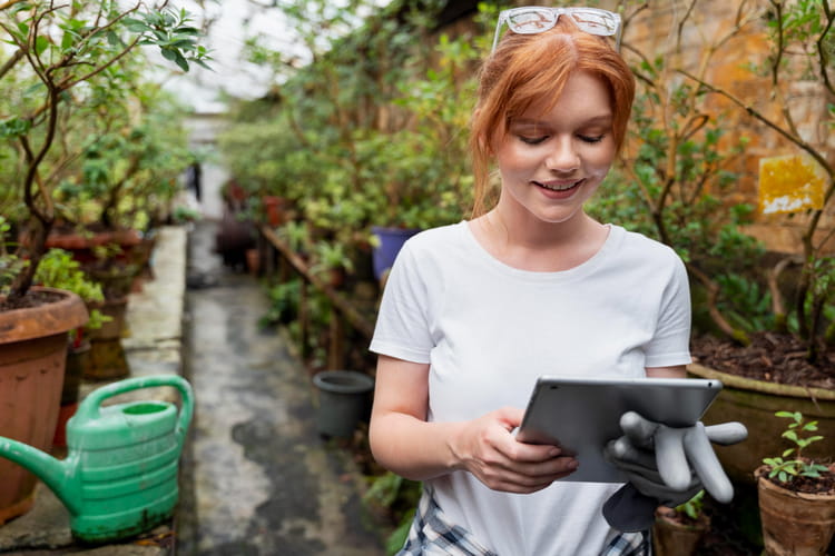 A woman using a tablet to track the progress of the landscape design project